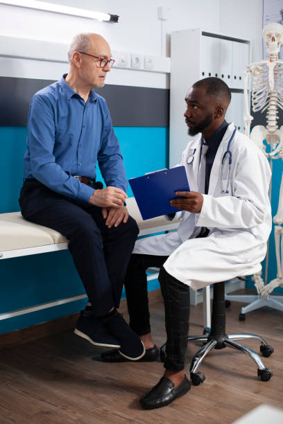 istock Retired man listening to black doctor 2197798594
