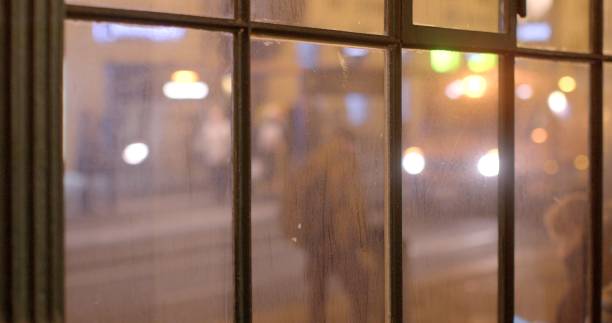 istock A blurry image of a person walking down a street at night 2197802099