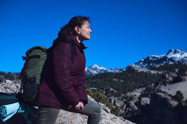 istock Young woman resting during a scenic mountain hike on a sunny day 2197802129