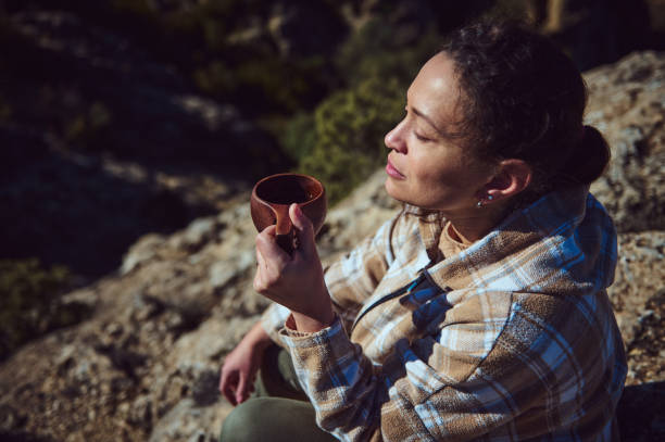 Woman enjoying outdoor serenity while drinking a warm beverage