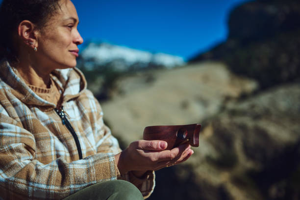 istock Relaxed Woman Outdoors Enjoys a Drink in a Natural Mountain Setting 2197802892