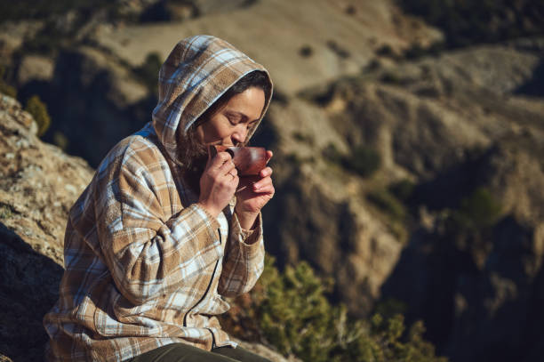 istock Woman enjoying a hot beverage in a serene outdoor mountain setting 2197802908