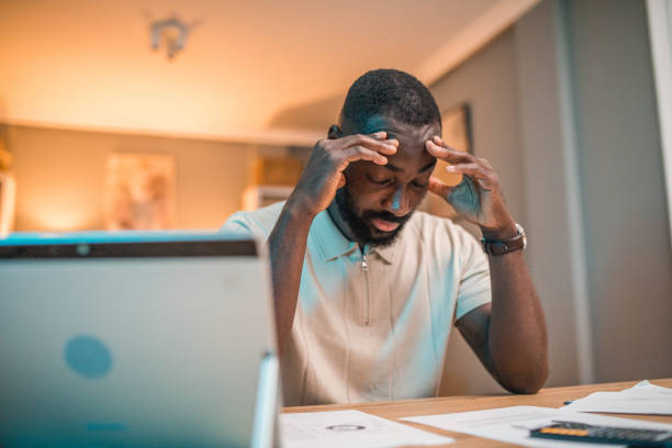 istock The black man has a headache from huge bills and household expenses 2197803433