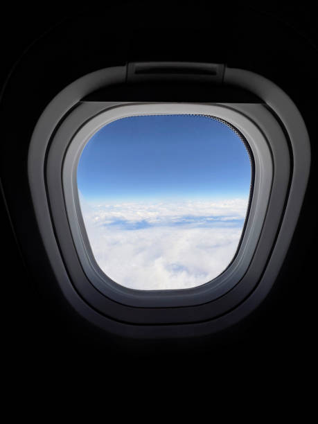 istock Airplane Window View of Clouds and Blue Sky 2197804036