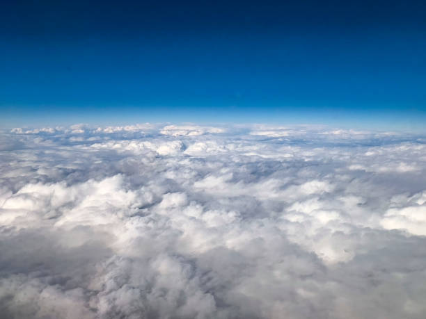 istock Aerial View of Clouds and Blue Sky from Airplane 2197804077
