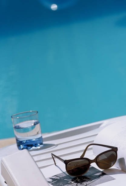 Closed umbrella next to the water pool