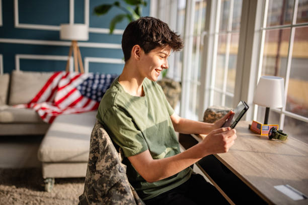 istock Female military member engaged in work using wireless technology in an office setting during daytime in the USA 2197807147