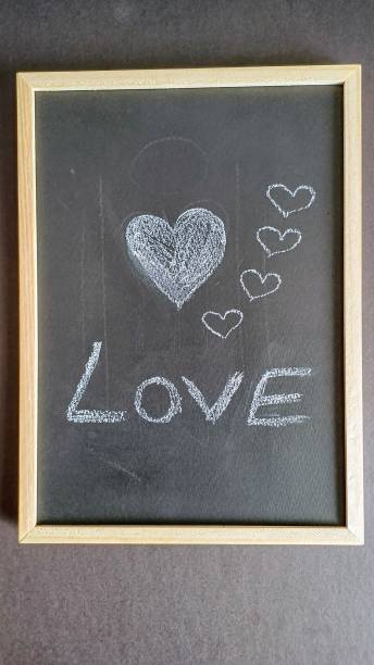 istock White background. Red heart on black chalkboard. Valentine's day. 2197809694