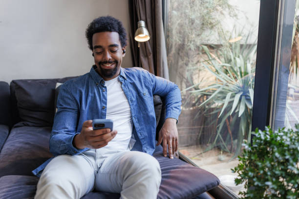 istock A smiling African American man relaxing on the couch at home 2197810044