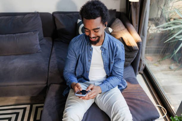 istock A smiling African-American man using smart phone at home 2197810060