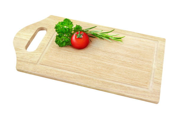 Wooden kitchen board with tomato and parsley isolated on white background