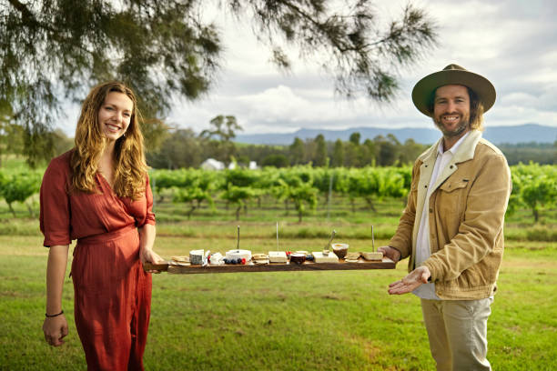istock Man and woman holding cheese board at Hunter Valley winery 2197811474