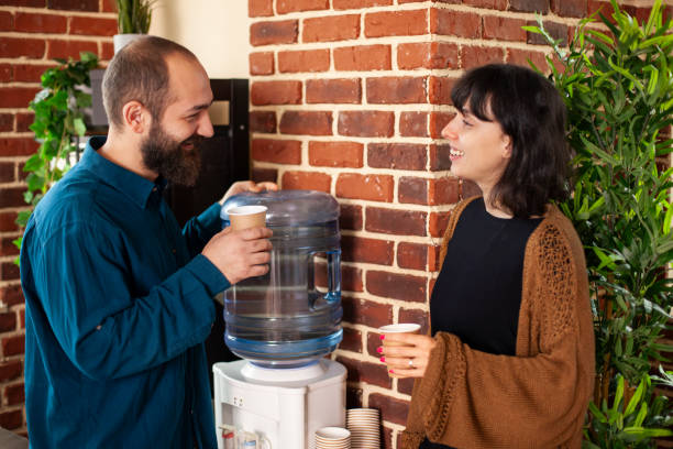 istock Colleague conversation near water cooler 2197812380