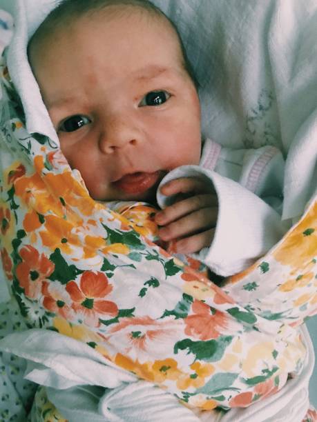 Babies. Newborn baby captured on smartphone. Natural lighting and intimate framing of innocence, warmth, and purity of child's first days. Mobile snapshot of first moments in family archive. Authentic