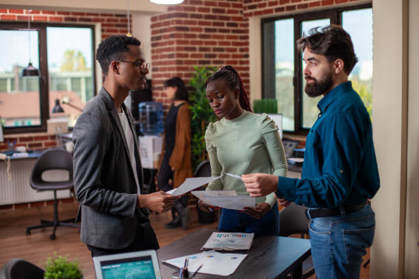 istock Coworkers compare strategy ideas at desk 2197812799