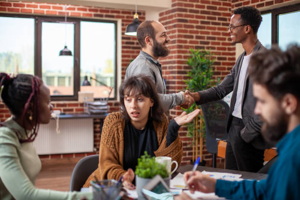 istock Male coworkers exchange greetings 2197813804