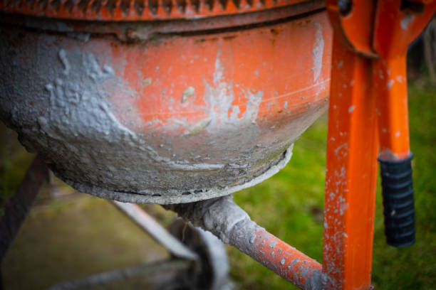 Orange concrete mixer close-up in standby mode.