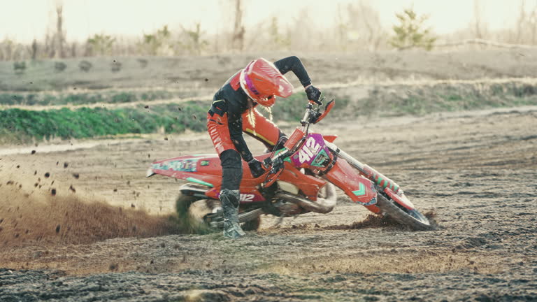 Caucasian Female Riding Motocross Bike at Sunset