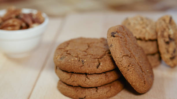 istock chocolate chip cookies with pecan on a wooden table close up 2197816037