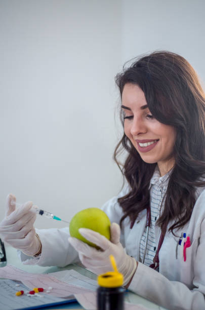 istock Female doctor with needle injected into green app 2197817616