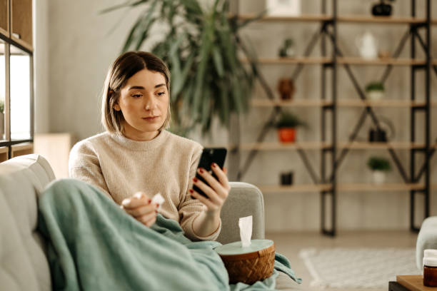 istock Sick woman resting on the couch 2197817814
