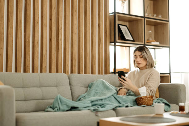 istock Sick woman resting on the couch 2197817821