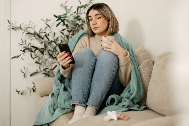 istock Sick woman resting on the couch 2197818044
