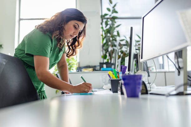 istock Focused professional engaged in task at a modern office workspace in Sydney, Australia during daytime 2197818609