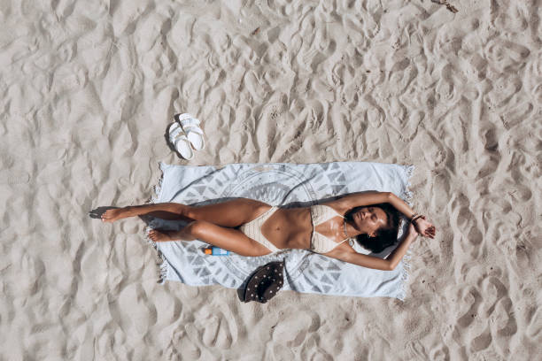 istock Beautiful young woman on the beach 2197819446