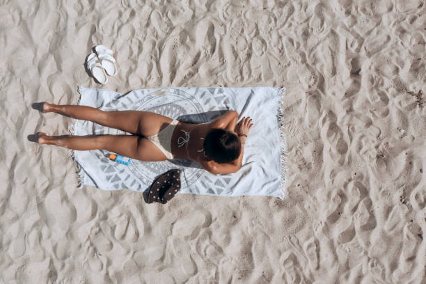 istock Beautiful young woman on the beach 2197819451