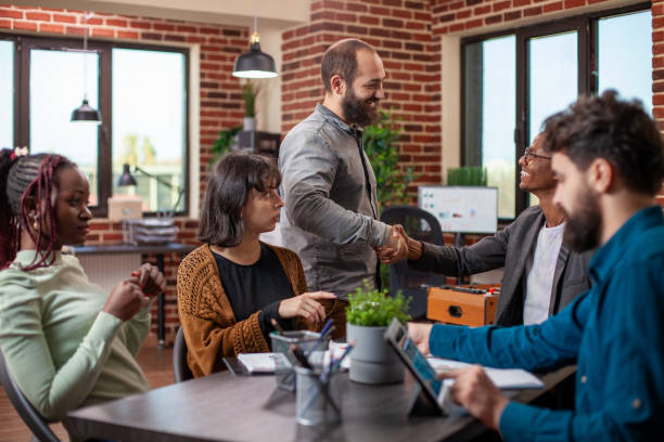 istock Manager greets colleague at meeting 2197820038