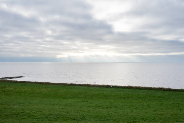 istock Typical dutch landscape, with a dyke and the sea 2197820998