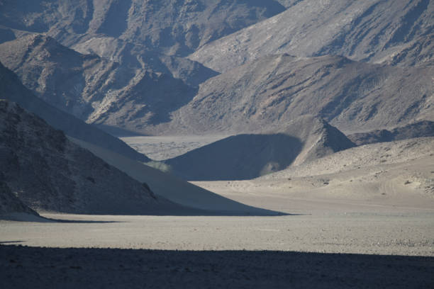The Hoanib Valley is in the middle of the photo. There are shadows forming in the valley and mountains at the top of the photo\nThe photo was taken in the Hoanib Valley, on the border of northern Damarland and Kaokoland, in north west Namibia in February 2024