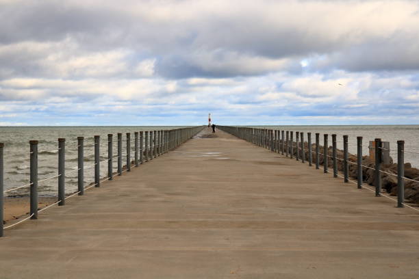 Ominous Skies Meet a Cement Pier Extending Into A Lake