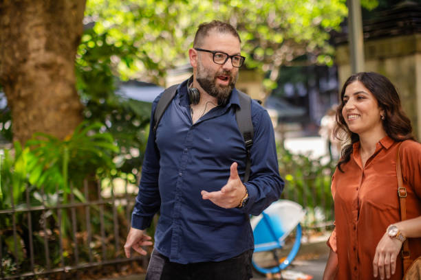 istock Two friends enjoying a lively conversation while exploring a sunny park in Sydney, Australia on a vibrant afternoon 2197823235