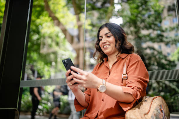 istock Woman enjoying her time in a park in Sydney while using her smartphone on a sunny day 2197824723