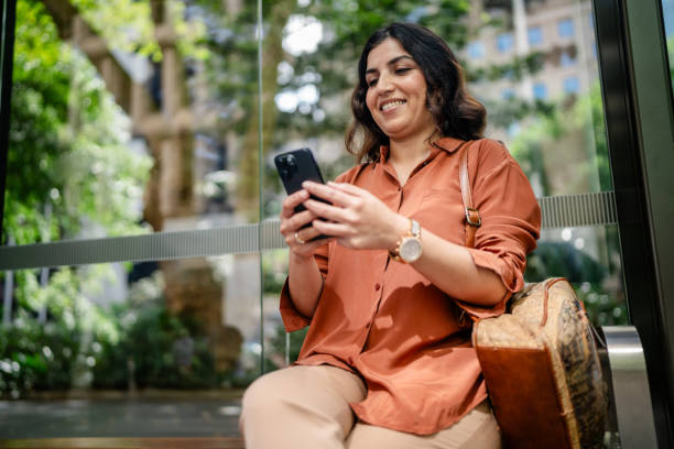 istock Woman enjoying her time while using a smartphone in a park in Sydney, Australia during a sunny day 2197824760