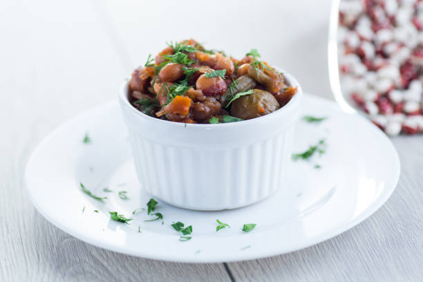 istock beans cooked with Brussel sprouts, tomatoes and other vegetables 2197825393