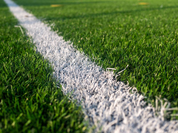 istock A white line is drawn on a green field 2197827616