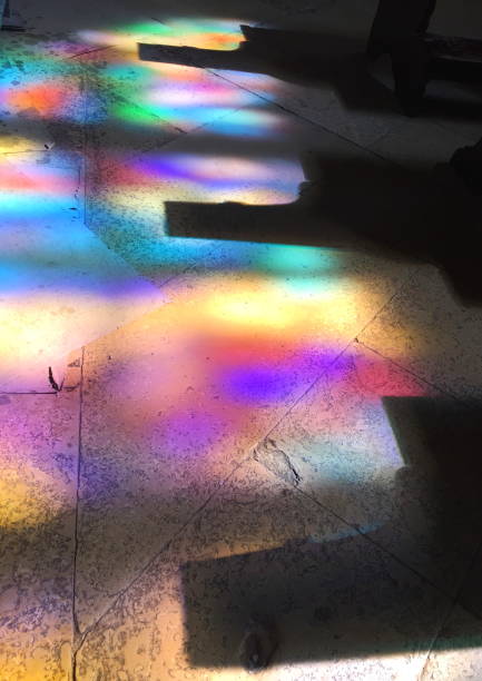 istock Abstract play of colorful light reflections on a stone floor, created by sunlight streaming through stained glass windows inside a historic church. Vibrant hues and shadows create a serene atmosphere 2197828345