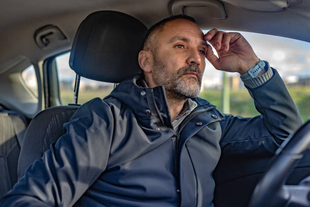 istock Thoughtful mature man driving a car 2197830352