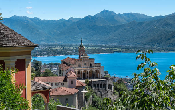 Madonna del Sasso church is situated scenically in front of a Lago Maggiore and Alpine background
