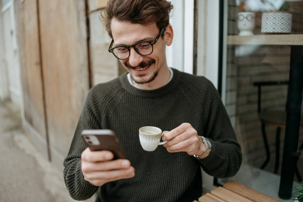 istock Man uses a mobile phone in a cafe 2197833822