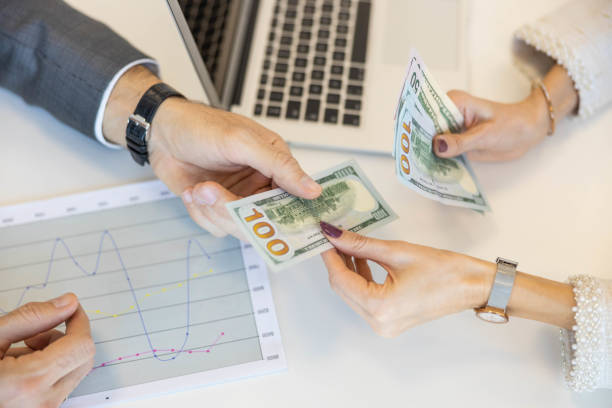 istock Close Up of Cash Transaction Taking Place 2197836755