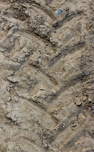 istock Tractor tire track imprint in dirt road 2197837152
