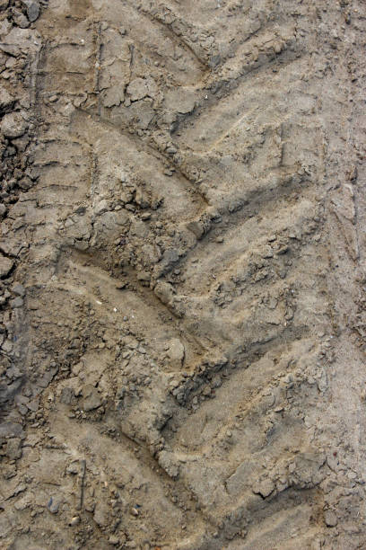istock Tractor tire track imprint in dirt road 2197837174