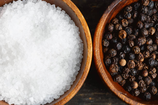 istock two bowls with black pepper and salt, close-up 2197838199