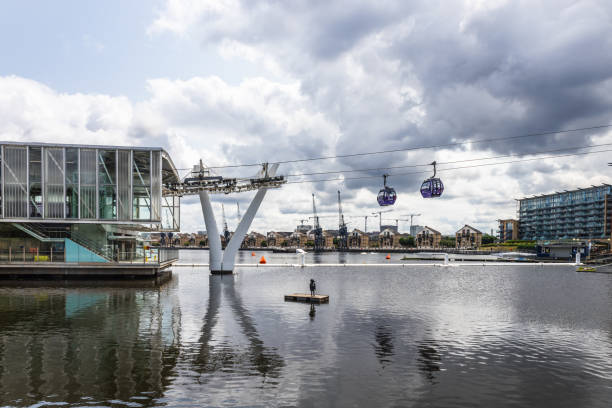 IFS Cloud Royal Docks. Modern Waterfront with Iconic Architecture and Dramatic Sky Experience IFS Cloud Royal Docks, where modern architecture meets serene water reflections under a dramatic cloudy sky. London, UK, 29 June 2023 what-if-concept stock pictures, royalty-free photos & images