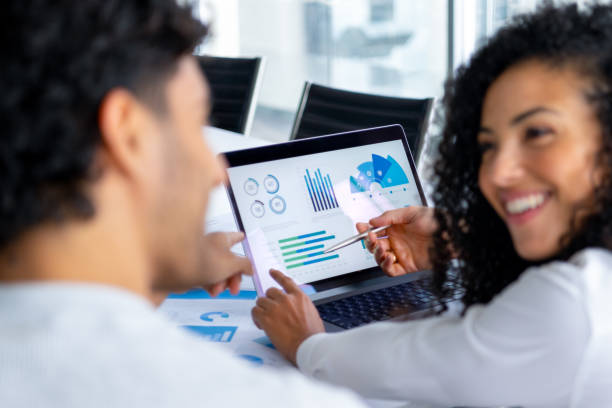 istock A couple looking at and discussing  financial data with graphs and charts. 2197844404