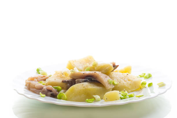 Traditional dinner - potatoes and herring, isolated on white background.